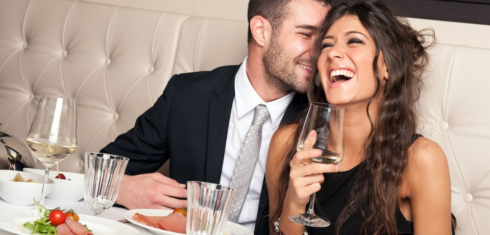Man and woman on a date thinking about sex. The woman is holding a glass with wine in it. 