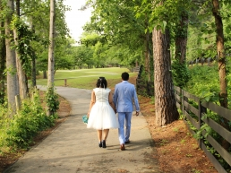 forsaking all others. African American couple holding hands, walking away through the forest.