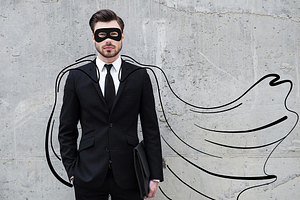 Man wearing a suit with a drawn cape on