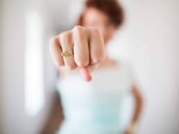 dating female holding fist out with ring on that says, 