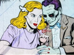 Cartoon drawing of a seemingly happy woman sharing a sundae with a zombie while ignoring the red flags