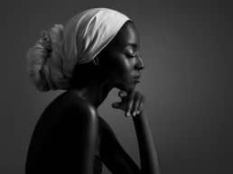 beautiful Black Woman with white head wrap thinking about her dating plight