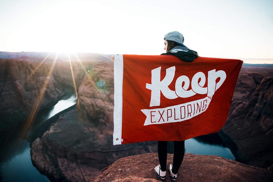 Dating Woman with flag that says keep exploring